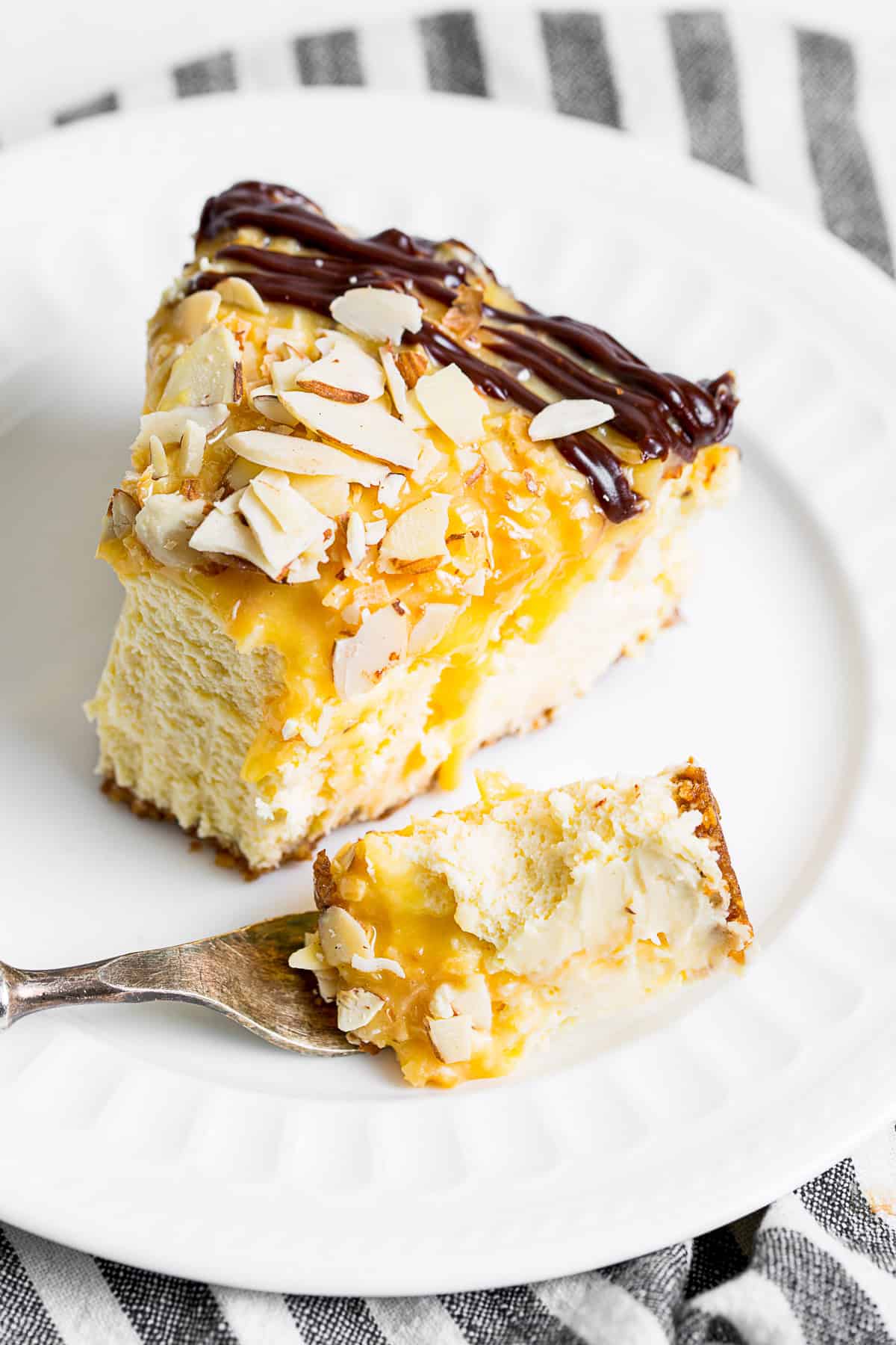 A slice of German Chocolate Cheesecake on a plate with a fork.