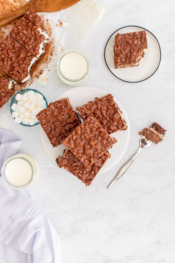 Peanut Butter Marshmallow Krispie Topped Brownies cute on a white plate.