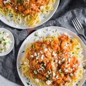 This pasta with shrimp and feta is a flavor-packed weeknight or special occasion meal. My husband grew up eating this dish and it's his all-time favorite. Garlicky shrimp mixed with a feta packed sherry tomato sauce served over perfectly cooked pasta - what's not to love? 