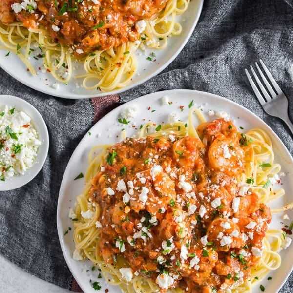 This pasta with shrimp and feta is a flavor-packed weeknight or special occasion meal. My husband grew up eating this dish and it's his all-time favorite. Garlicky shrimp mixed with a feta packed sherry tomato sauce served over perfectly cooked pasta - what's not to love?Â