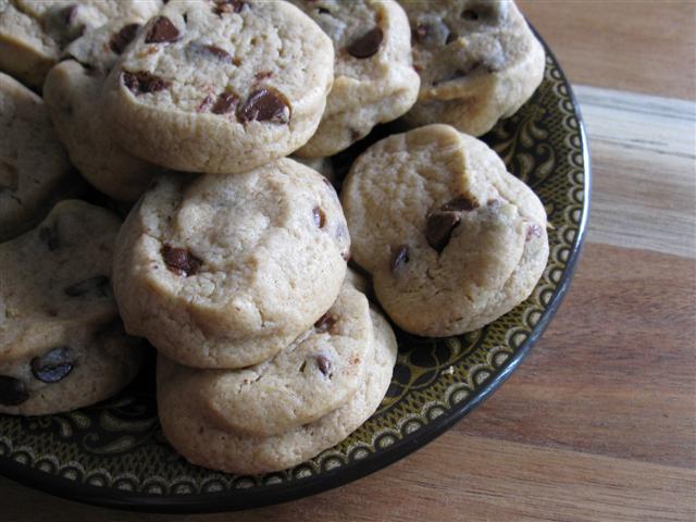 Chewy Chocolate Chip Cookies via Nutmeg Nanny Chewy Chocolate Chip Cookies on a plate.
