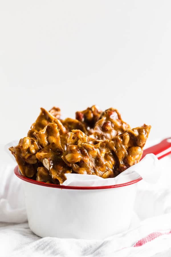 Homemade Maple Peanut Brittle served in parchment paper.