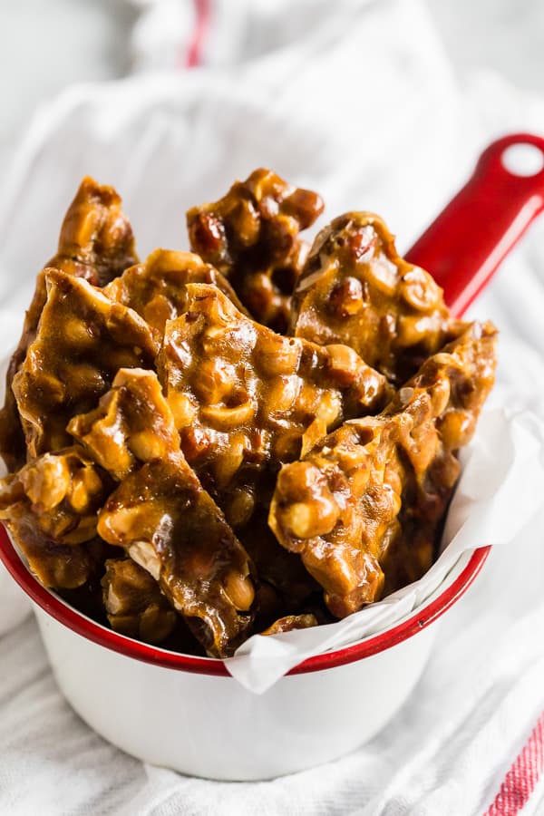 Homemade Maple Peanut Brittle in a little tin.