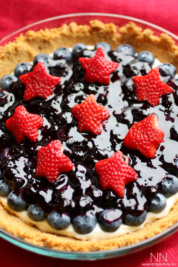 Red, White and Blueberry Sour Cream Tart by Nutmeg Nanny Blueberry Sour Cream Tart topped with berries.