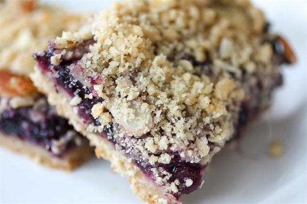 These blueberry crumb bars are packed full of fruity flavor and topped with a crumbly oat and almond topping. Super simple to make and totally delicious in every single way.