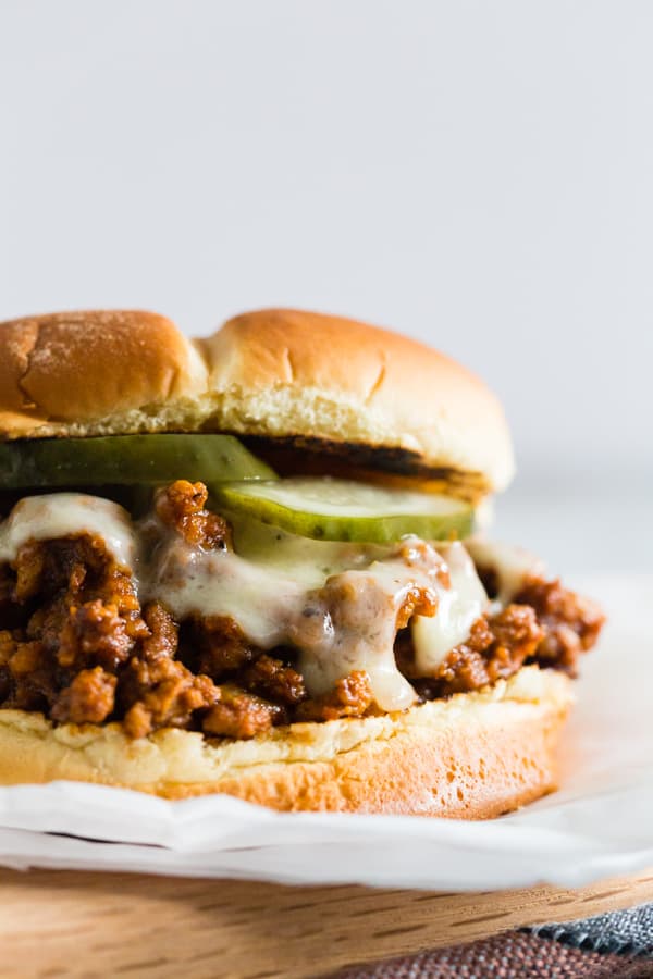 Sloppy Cubanos topped with cheese.
