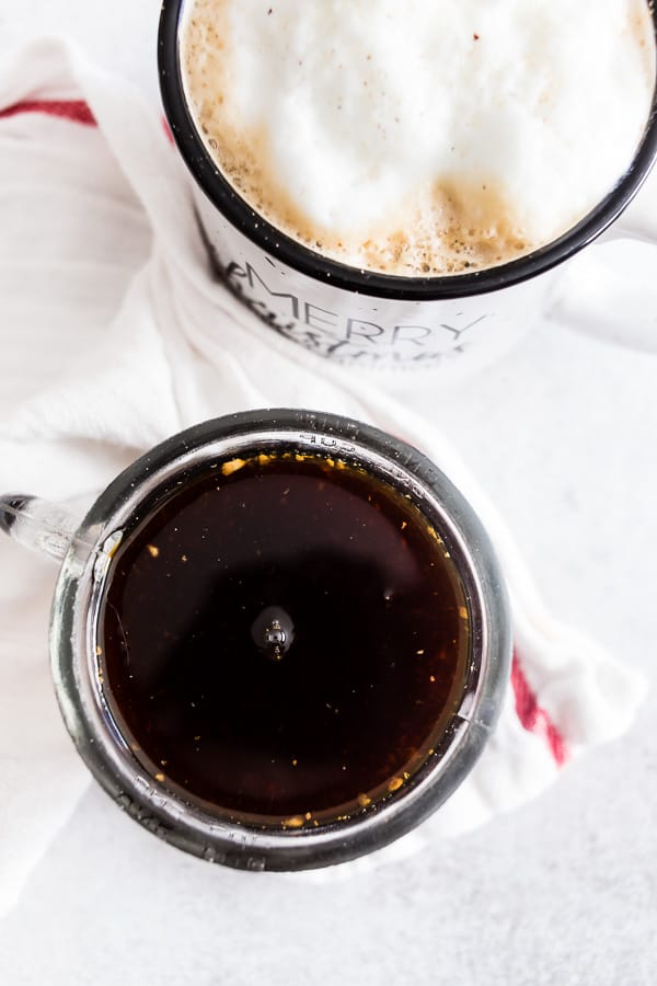 Homemade Gingerbread Syrup with a coffee on a white table.