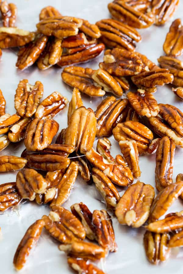Candied pecans on parchment paper.