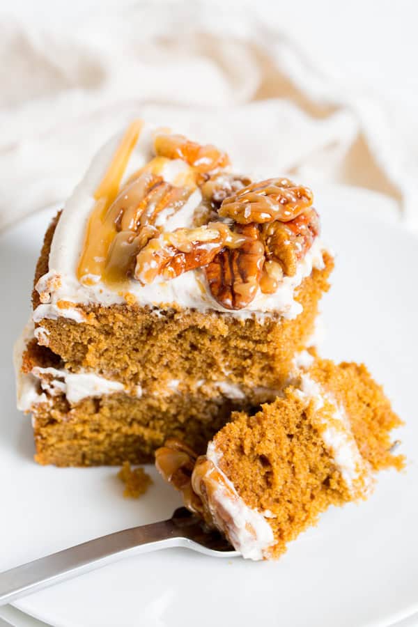 A sliced of Maple Gingerbread Layer Cake on a plate with a fork.