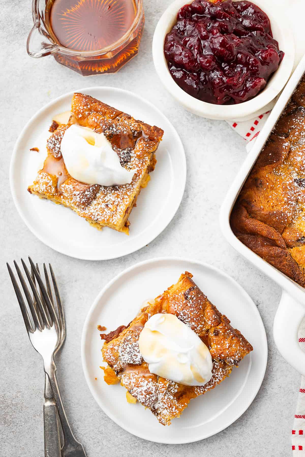 Panettone Bread Pudding cut into slices and topped with greek yogurt and maple syrup. 