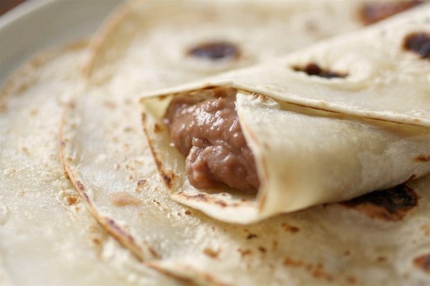 These Southern style pinto beans only take 4 ingredients and cost less than $5 to make! They are perfect eaten plain or rolled up in a soft flour tortilla.