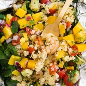 These shrimp couscous packets with avocado mango salsa are the perfect throw it together dinner. All you need to do is wrap it all up in foil, bake or grill and top with salsa. So easy and totally delicious! Ready in under 30 minutes!