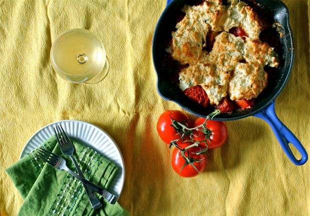Savory Tomato Cobbler in a skillet on a table. 