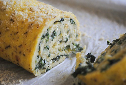 Spinach Artichoke Egg Roulade on a serving tray. 