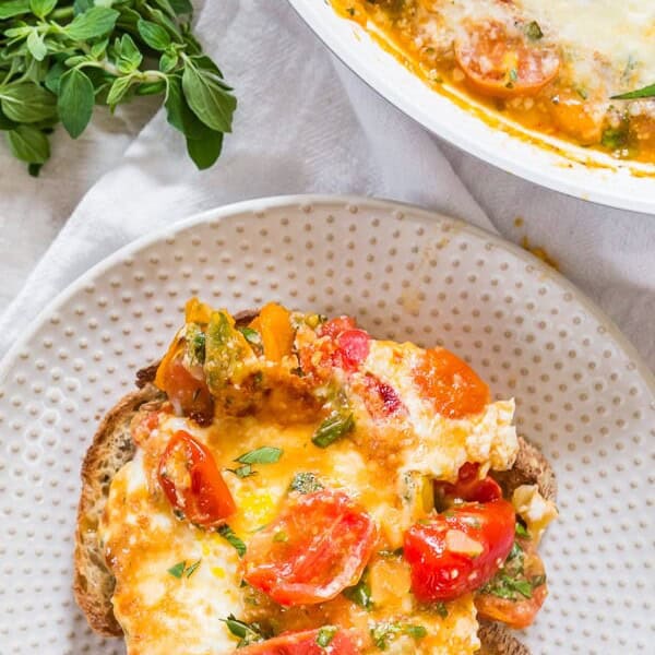 These bruschetta baked eggs are the perfect weekend brunch addition. Sweet sauteed tomatoes mixed with lots of garlic, basil, and oregano and topped with eggs and Parmesan cheese. Serve it over toast and enjoy your weekend! 