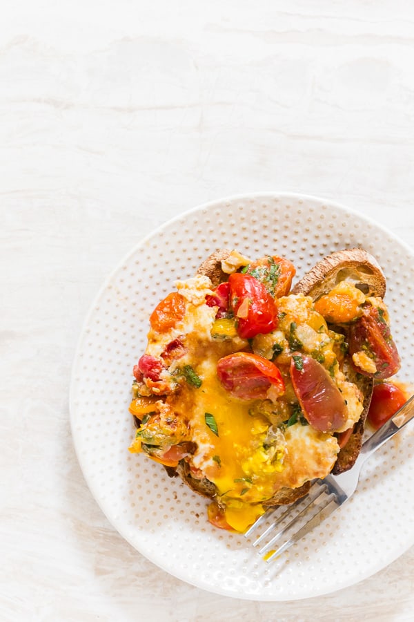 Bruschetta Baked Eggs served on a plate. 