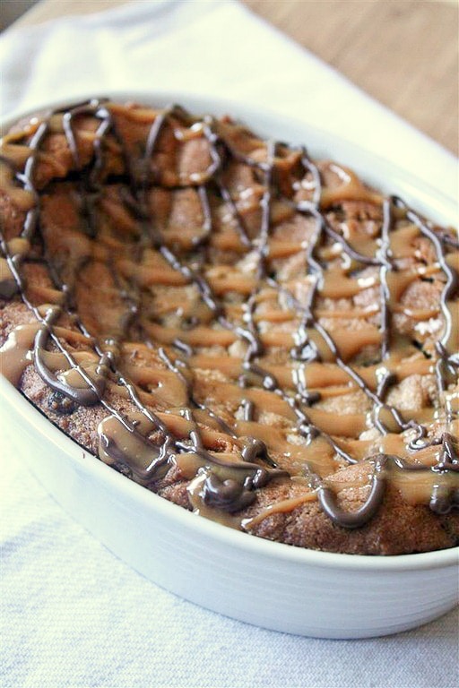 This super deep dish chocolate chip cookie is packed full of flavor and drizzled with melted chocolate and lots of salted caramel.