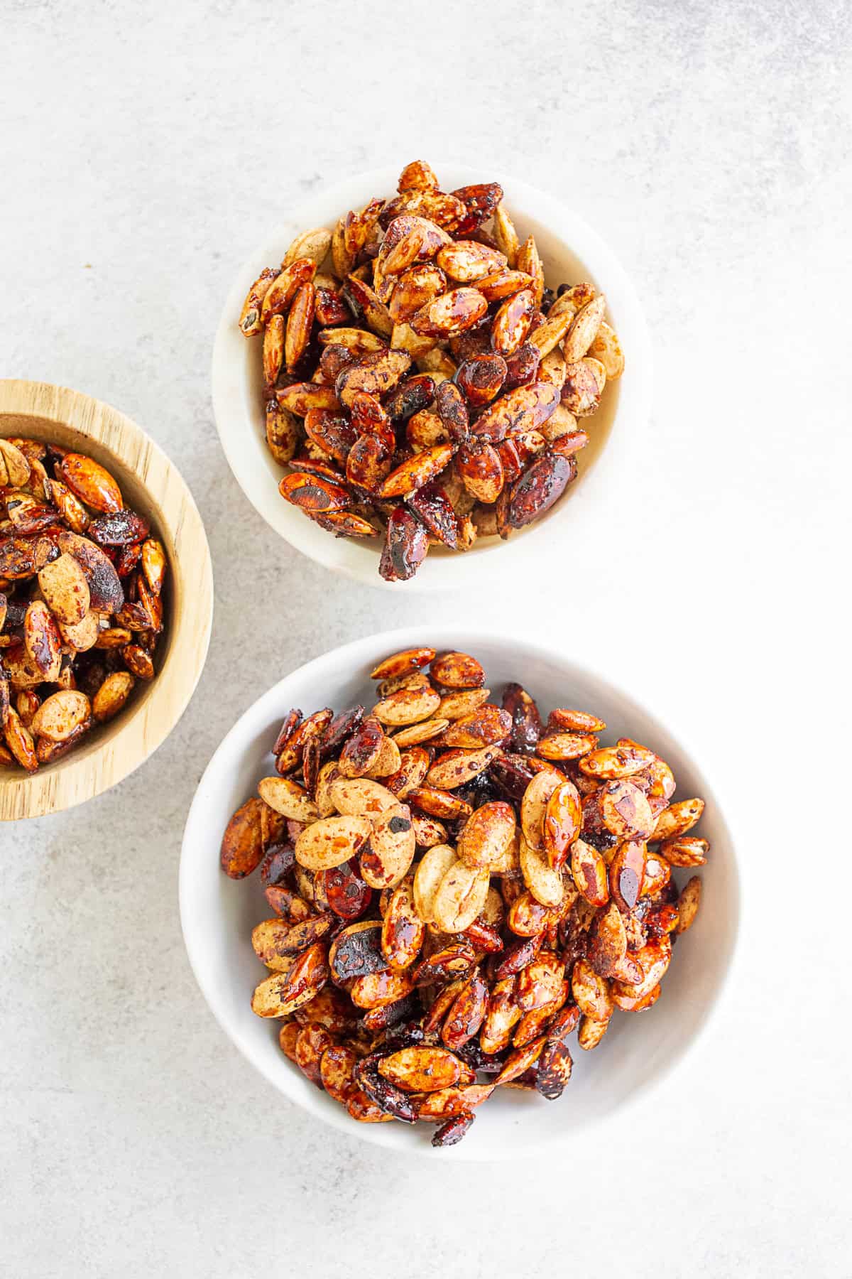 Sweet Salty Roasted Pumpkin Seeds in three small bowls.