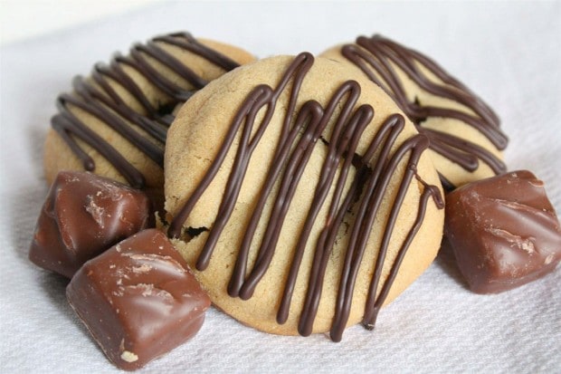 Peanut Butter Snickers Cookies by Nutmeg Nanny Sweet peanut butter Snicker cookies drizzled with chocolate and made with love. They are the perfect addition to your Christmas platter.