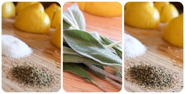 Lemon, herbs, kosher salt, and black pepper on a cutting board. 