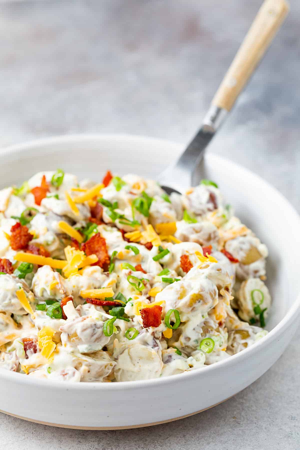 Bacon Ranch Potato Salad by Nutmeg Nanny Bacon Ranch Potato Salad in a bowl topped with extra bacon.