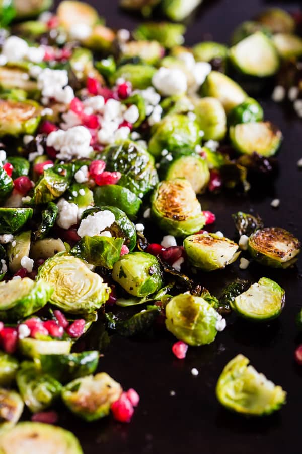 These super simple roasted Brussels sprouts with pomegranate seeds and goat cheese are the perfect dish for your Thanksgiving table. Easy to throw together and packed full of flavor! 
