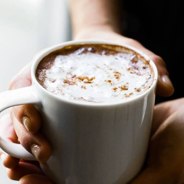 Holding a mug of Vitamix hot chocolate