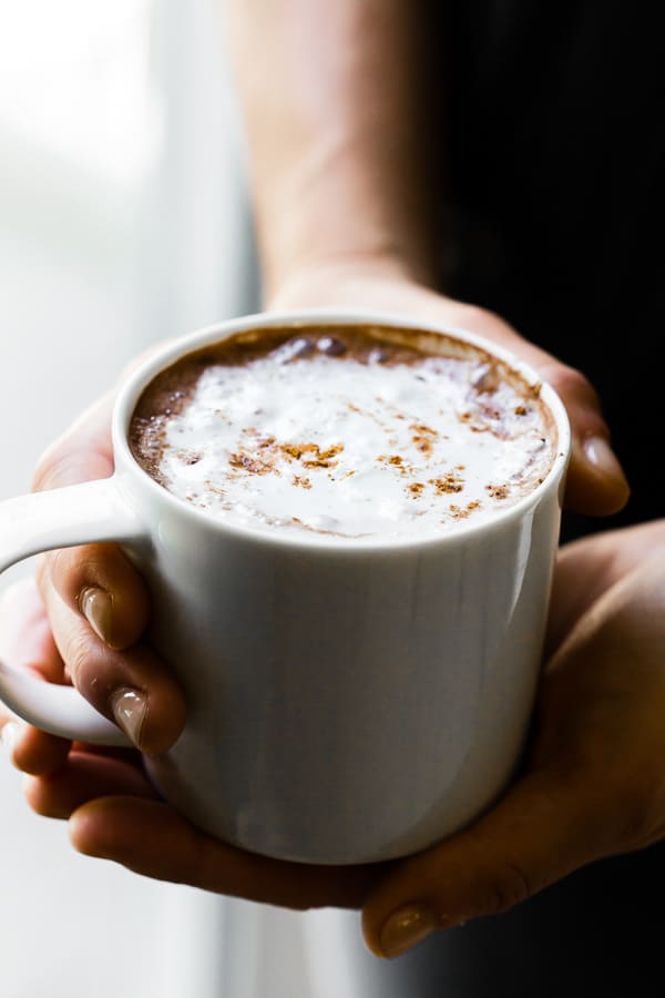 Holding a mug of Vitamix hot chocolate