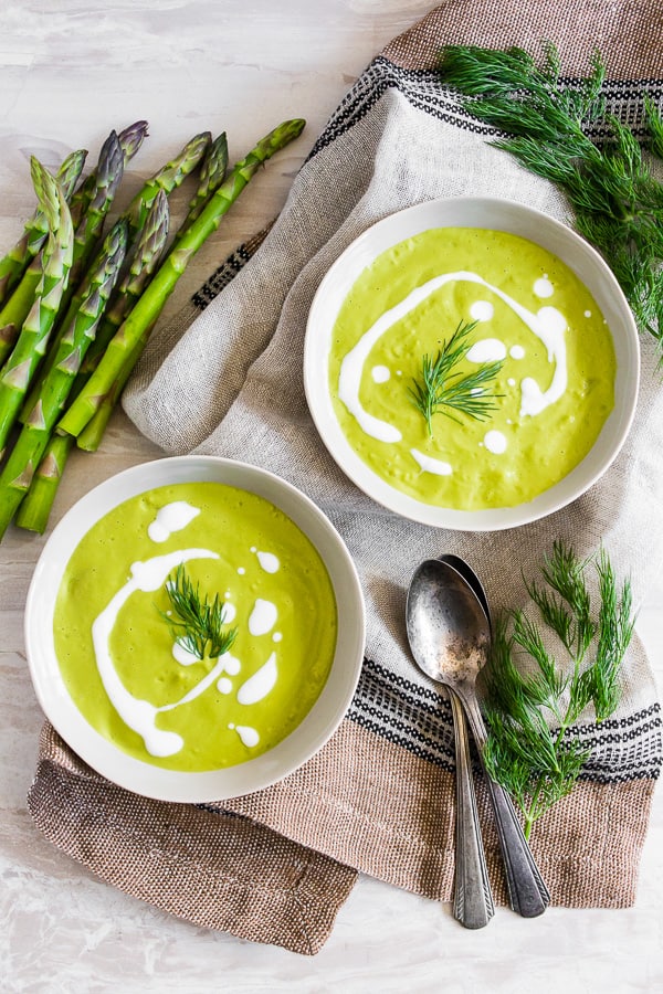 overhead shot of Cream of Roasted Asparagus Soup in bowls