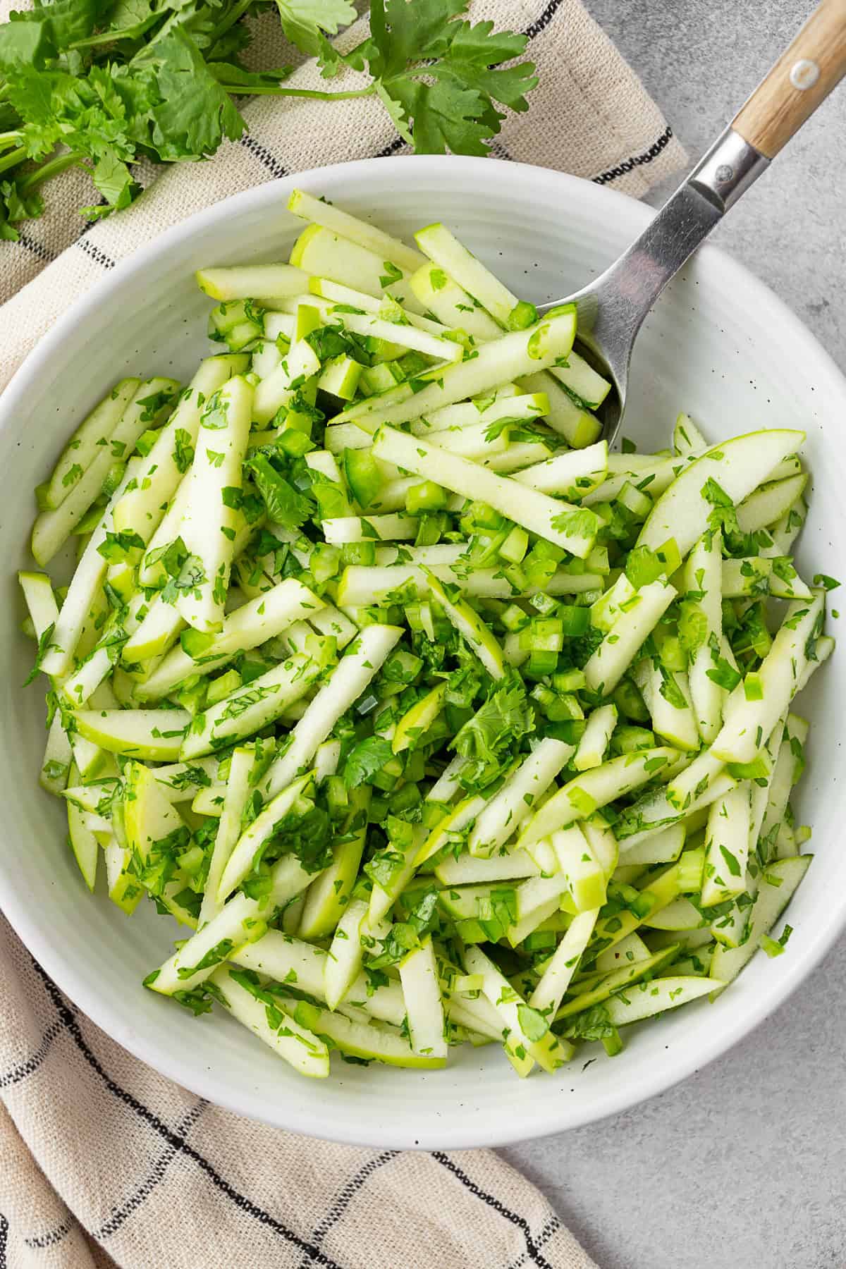 Cilantro Apple Slaw in a white bowl. 