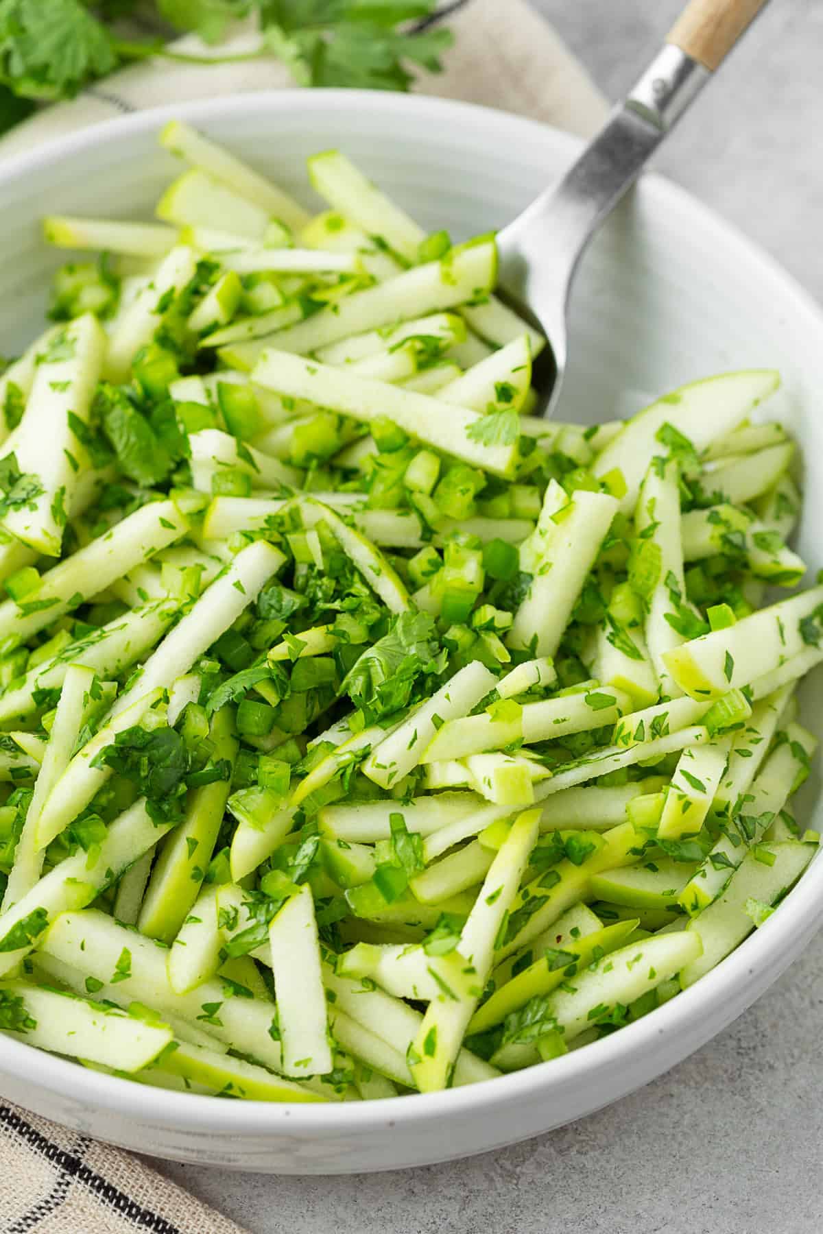 Cilantro Apple Slaw topped with extra cilantro. 