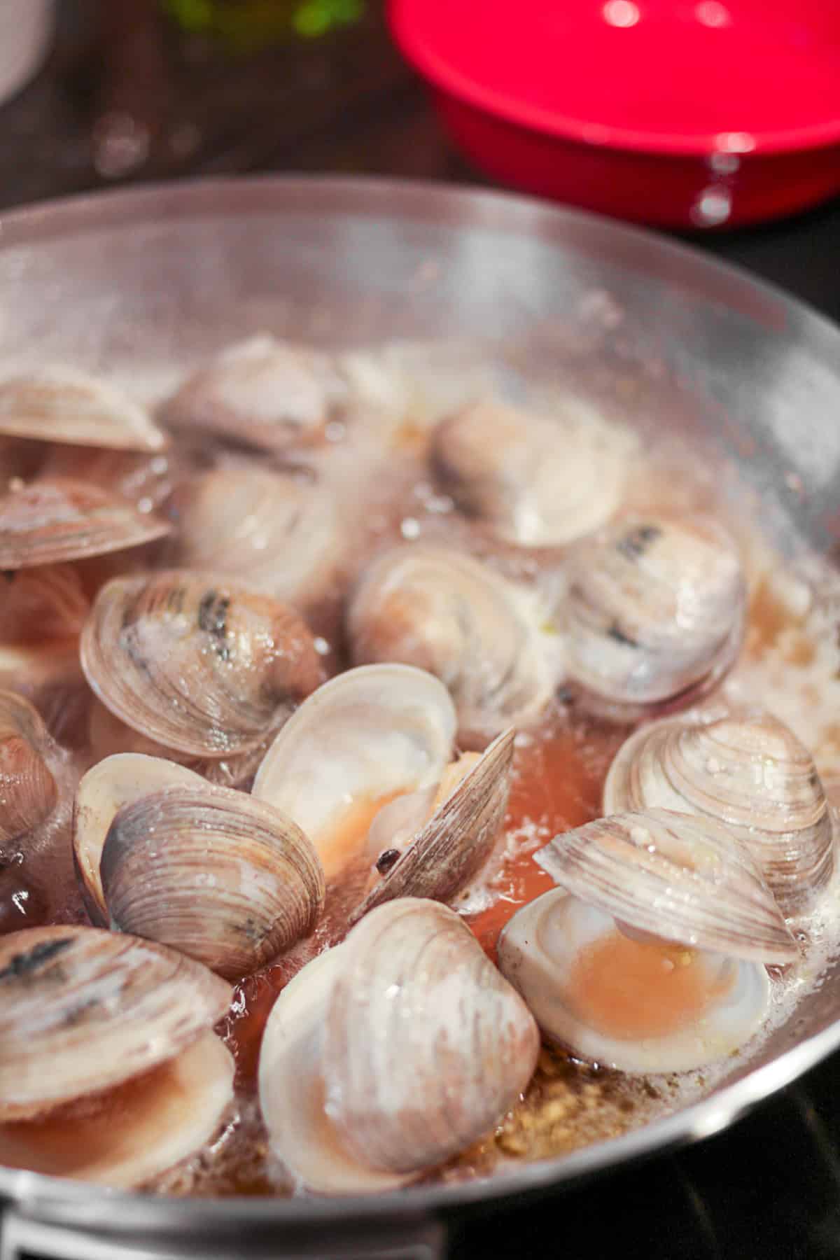 Clams steaming in a pan. 