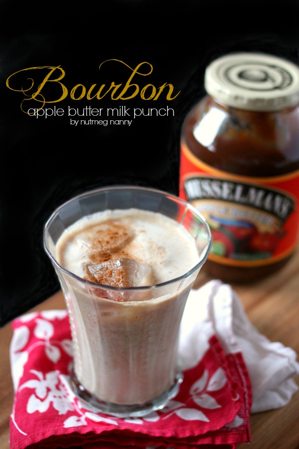 Bourbon Apple Butter Milk Punch in a glass with apple butter in the background. 