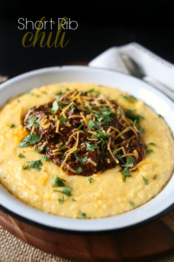 Short Rib Chili in a bowl with cilantro and shredded cheese. 
