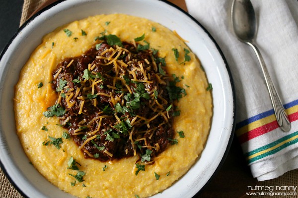 Short Rib Chili in a bowl spooned over polenta. 