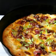 loaded baked potato pizza in a cast iron skillet