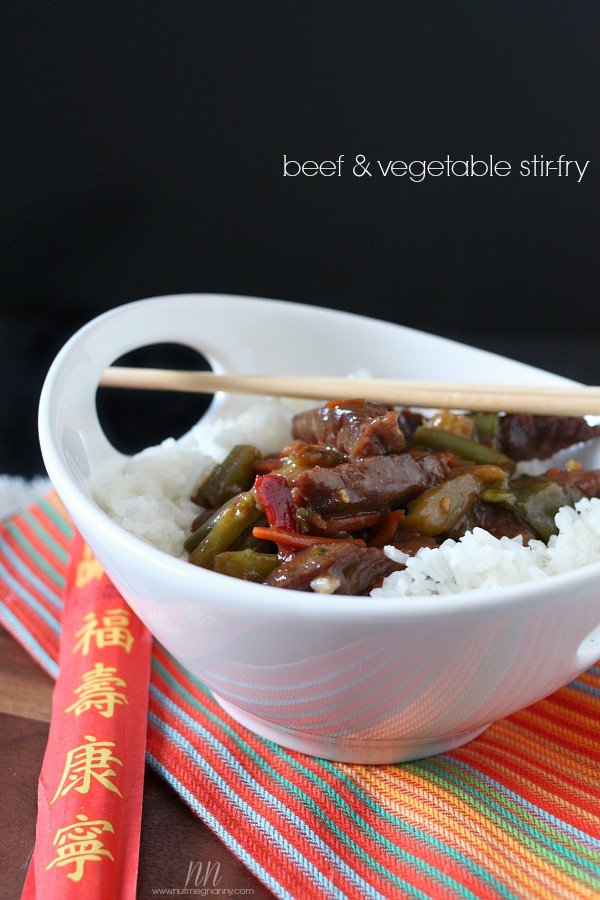 Beef and Vegetable Stir-Fry in a bowl with rice and chopsticks. 