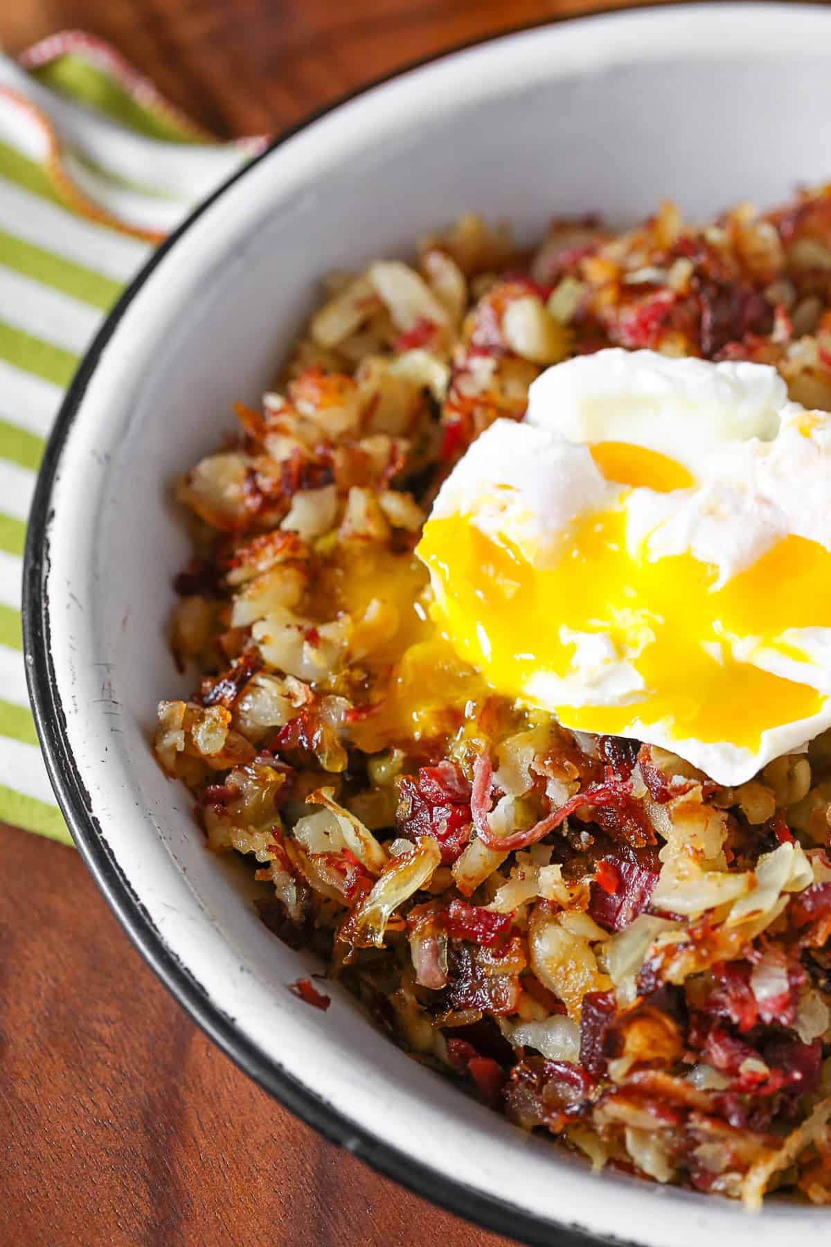 Corned Beef Hash in a bowl with a poached egg.
