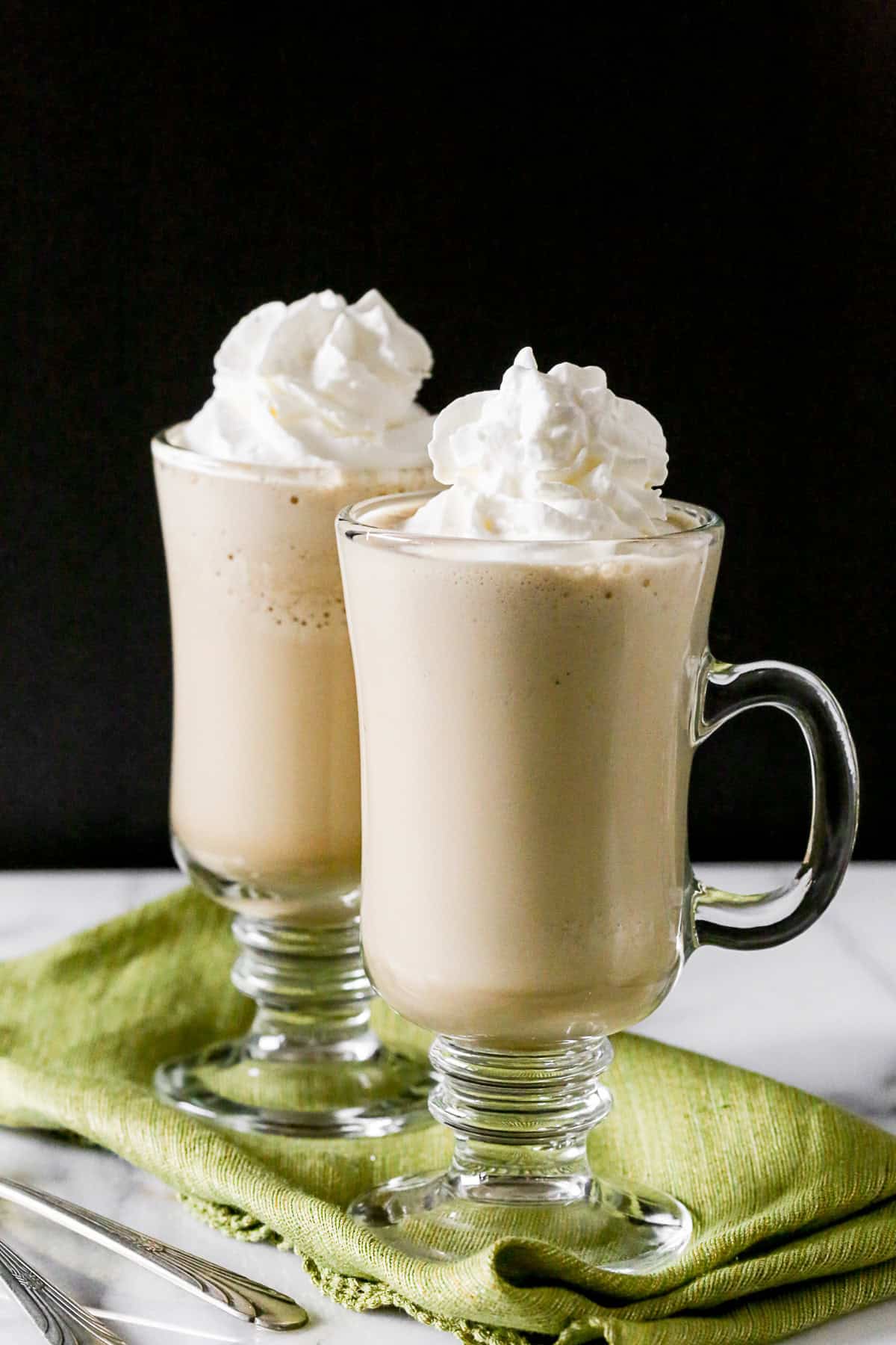 Two glasses of Irish Coffee Frappe topped with whipped cream.
