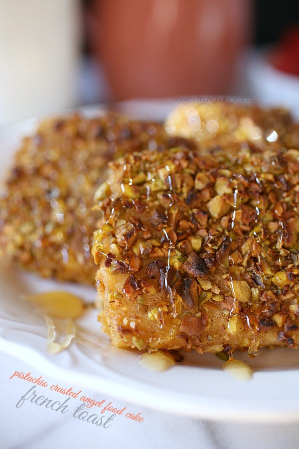 This pistachio crusted angel food cake French toast is perfectly sweet and has just the right amount of nut crunchiness. Drizzle with honey and devour.