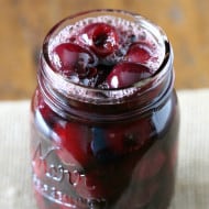pickled cherries in a glass quart jar