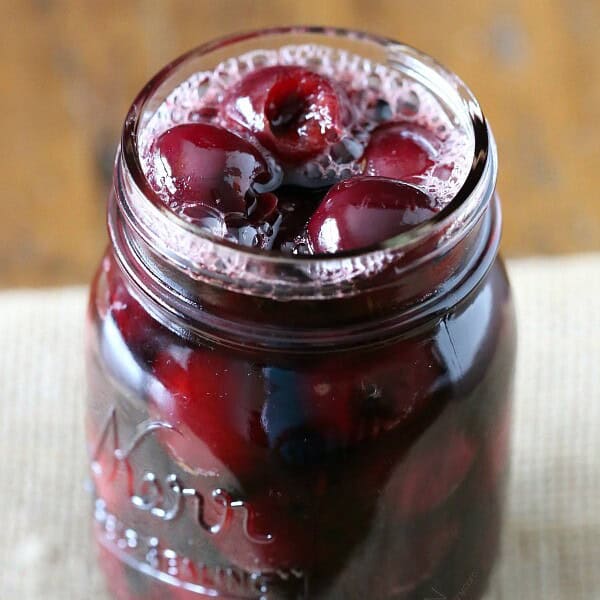 pickled cherries in a glass quart jar
