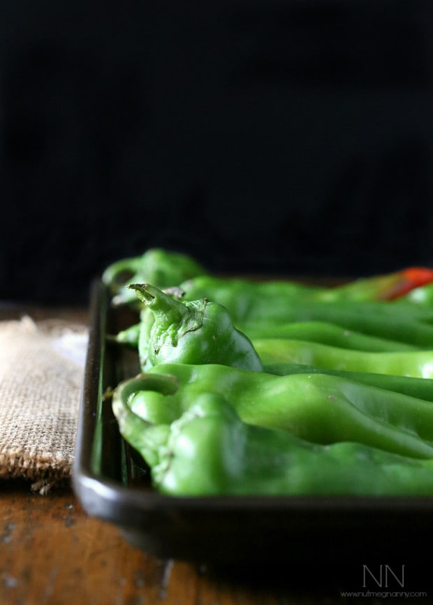 hatch green chiles sitting on a baking sheet.