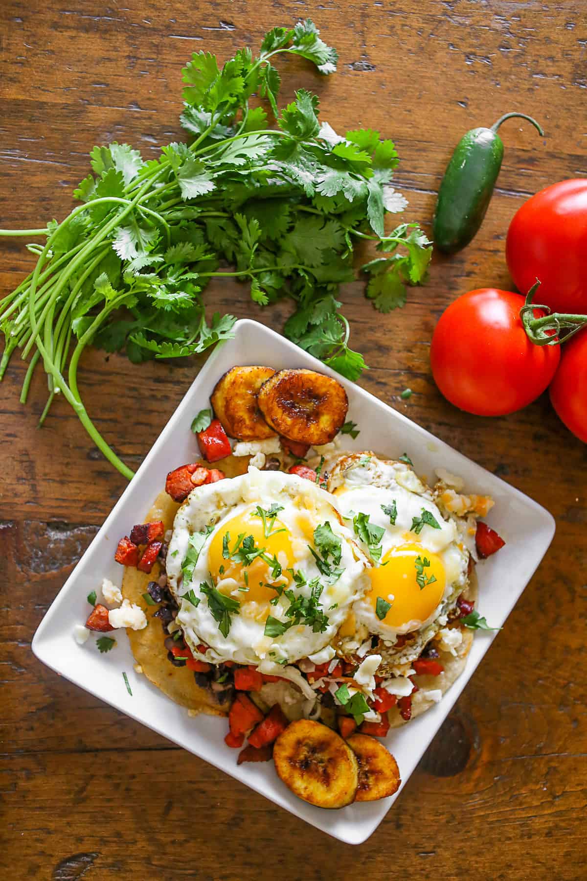 Huevos Motuleños topped with minced cilantro. 