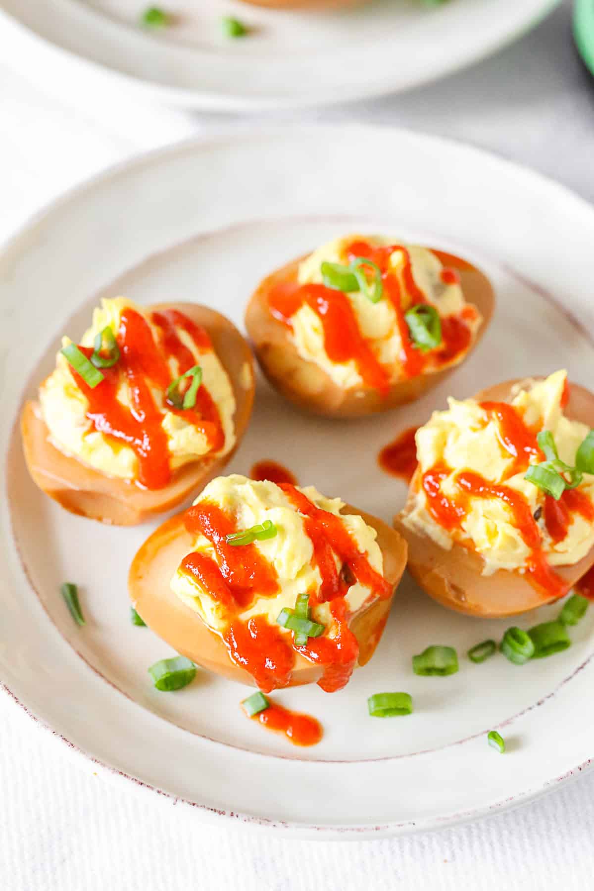 Soy Sauce Deviled Eggs garnished with green onions. 