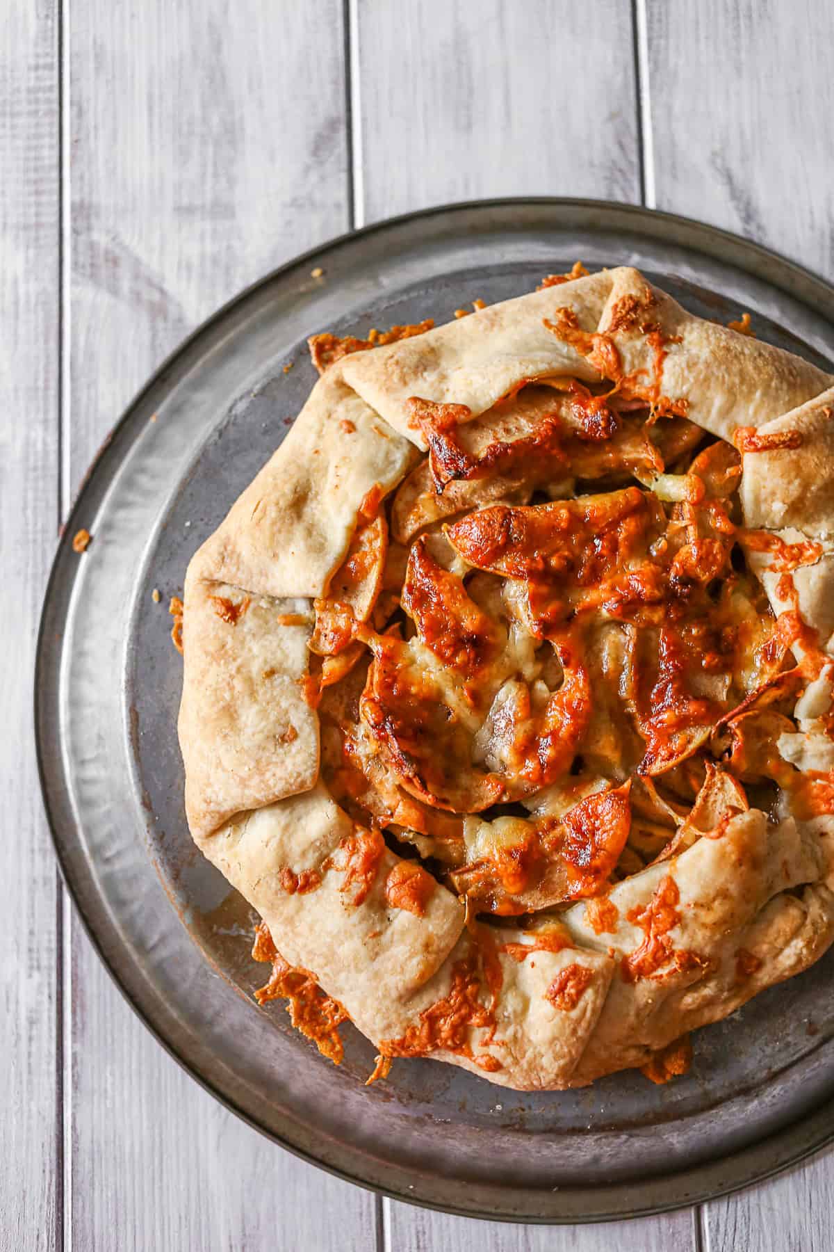 Apple Cheddar Galette sitting on a metal tray. 