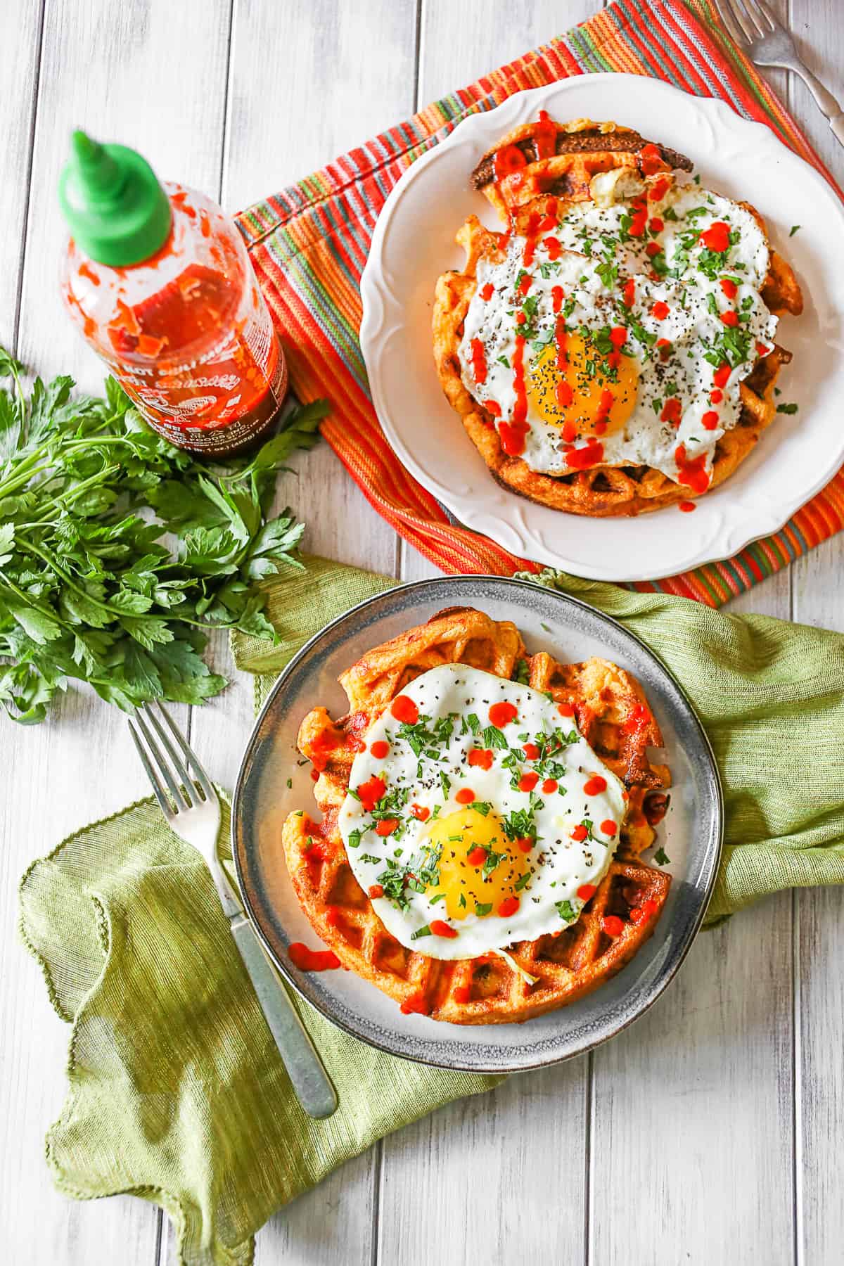 Cheddar Sausage Cornmeal Waffles on 2 plates. 