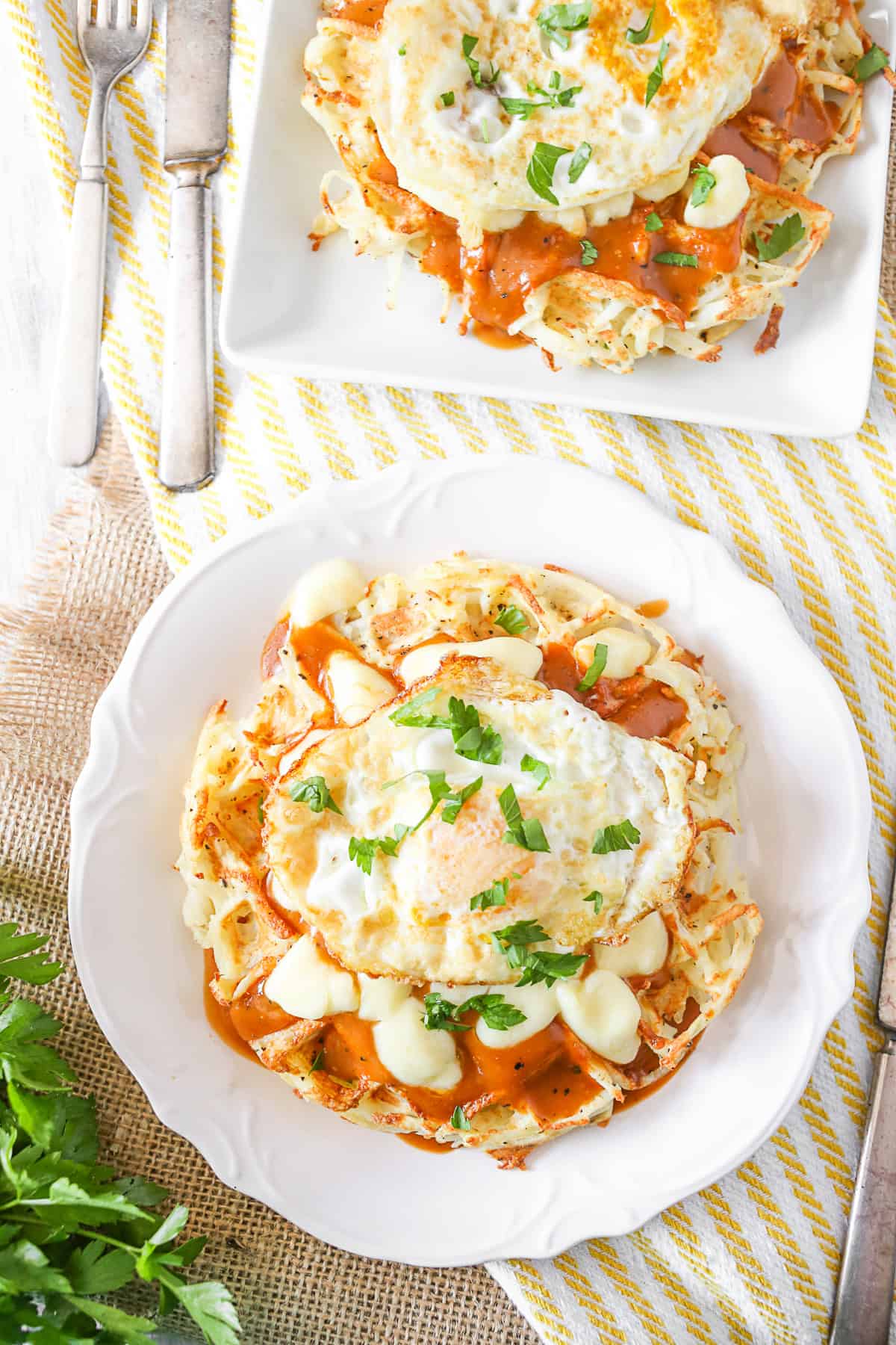 Poutine Hash Brown Waffles served on 2 plates. 
