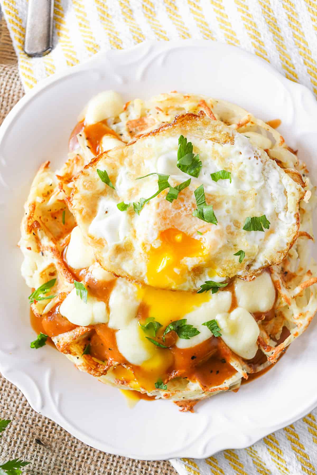 Poutine Hash Brown Waffles topped with a fried egg. 