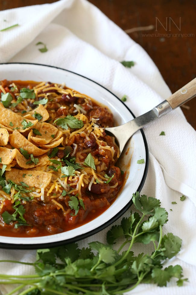 This slow cooker pumpkin chili is packed full of pumpkin puree, spicy Italian sausage and lots of beans and vegetables. This hearty soup is perfect for cold winter nights.